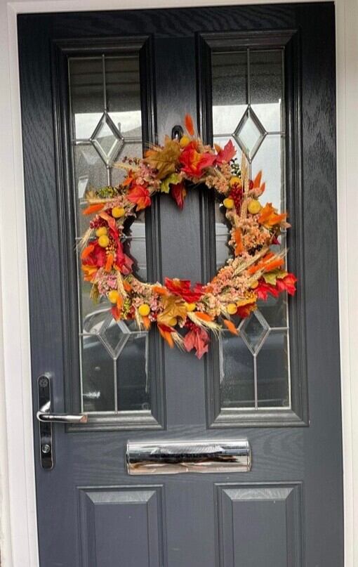 Image of a Flower Wreath made by Bloom and Grow on a black door
